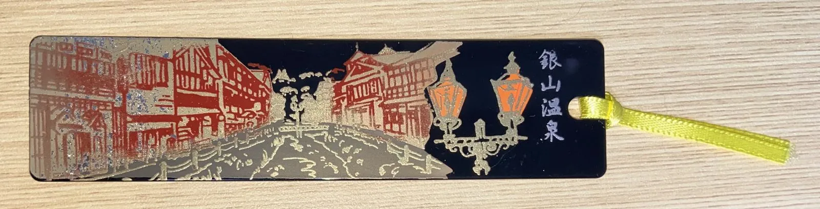 Ginzan Onsen bookmark: the gas-lit street etched in gold and red on black lacquer